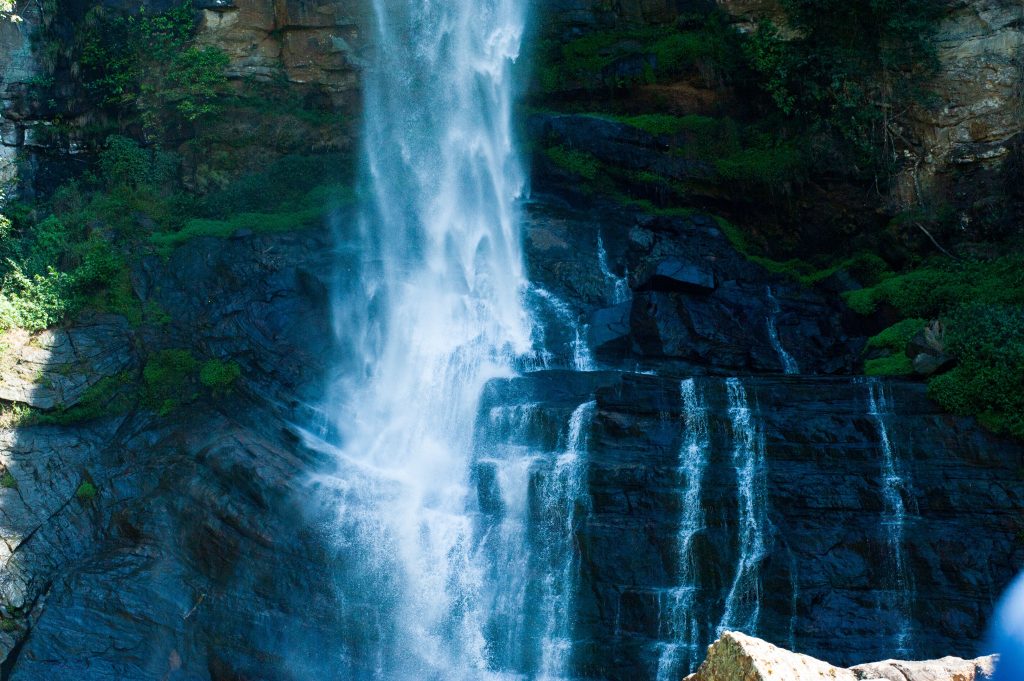 Stunning view of Ramboda Waterfall cascading down rocky cliffs in Sri Lanka.